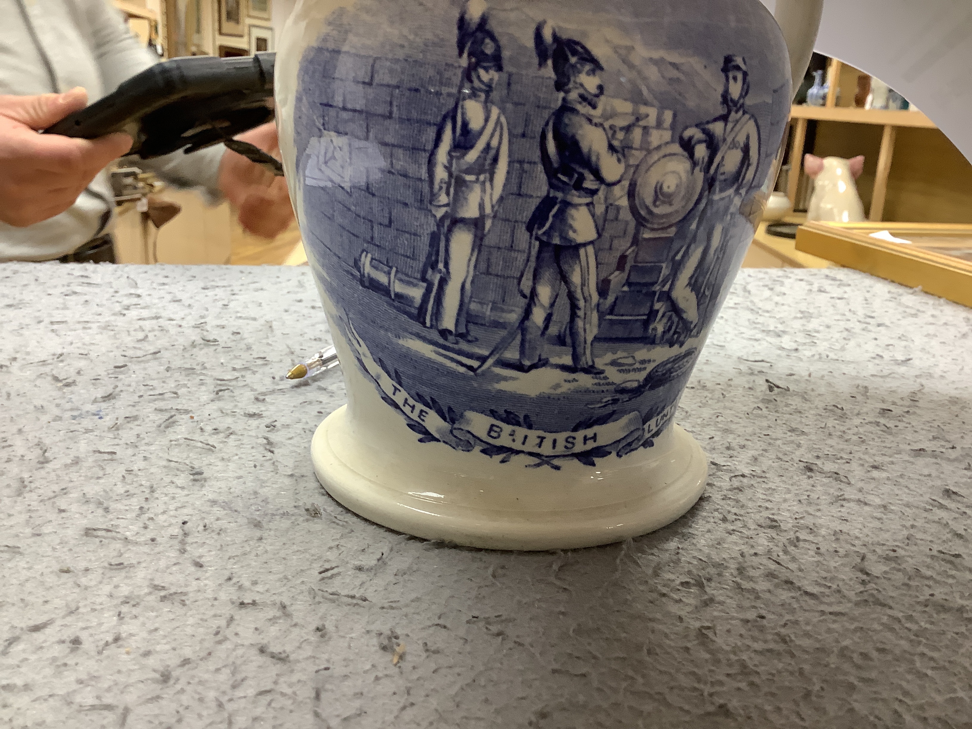 Seven military and naval themed jugs including a Leeds creamware jug 'Loyal Volunteers' inscribed 'L Volnteers' c.1803, an early 19th century success to the volunteers jug, a Sunderland pink splash lustre loving cup etc.